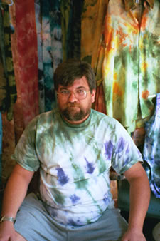 George Hummel displays Nancy's tie dye fabrics.